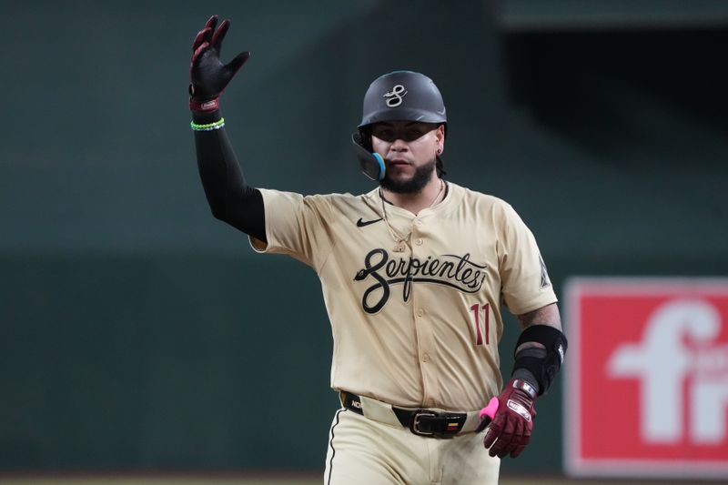 Sep 10, 2024; Phoenix, Arizona, USA; Arizona Diamondbacks catcher Jose Herrera (11) reacts after hitting a single against the Texas Rangers in the fourth inning at Chase Field. Mandatory Credit: Rick Scuteri-Imagn Images