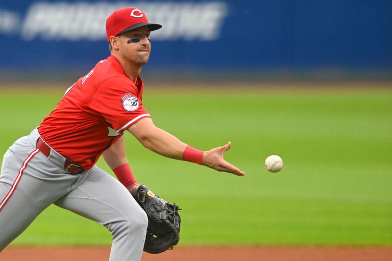 Jun 10, 2025; Cleveland, Ohio, USA; Cincinnati Reds first baseman Spencer Steer (7) tosses the ball to first base in the second inning against the Cleveland Guardians at Progressive Field. Mandatory Credit: David Richard-Imagn Images