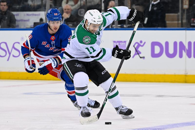 Jan 7, 2025; New York, New York, USA;  Dallas Stars center Logan Stankoven (11) plays the puck chased by New York Rangers left wing Will Cuylle (50) during the third period at Madison Square Garden. Mandatory Credit: Dennis Schneidler-Imagn Images