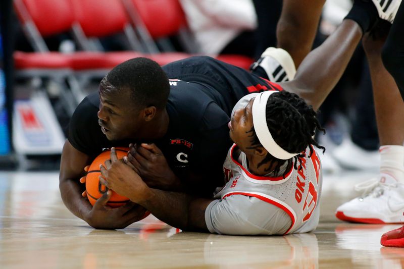 Jan 3, 2024; Columbus, Ohio, USA; Rutgers Scarlet Knights forward Mawot Mag (left) and Ohio State Buckeyes center Felix Okpara (34) go for the loose ball during the first half at Value City Arena. Mandatory Credit: Joseph Maiorana-USA TODAY Sports