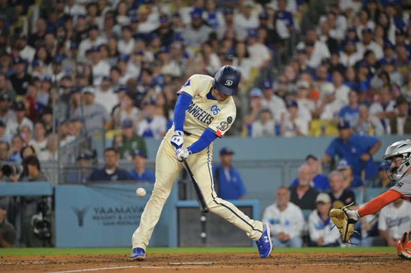 Sep 20, 2025; Los Angeles, California, USA; Los Angeles Dodgers first base Freddie Freeman (5) hits an RBI single during the third inning against the San Francisco Giants at Dodger Stadium. Mandatory Credit: Jayne Kamin-Oncea-Imagn Images