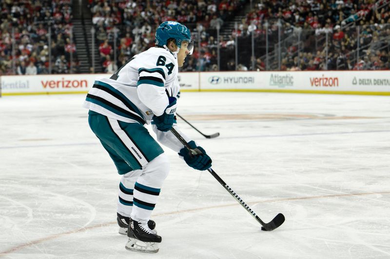 Nov 10, 2024; Newark, New Jersey, USA; San Jose Sharks center Mikael Granlund (64) looks to pass the puck against the New Jersey Devils during the first period at Prudential Center. Mandatory Credit: John Jones-Imagn Images