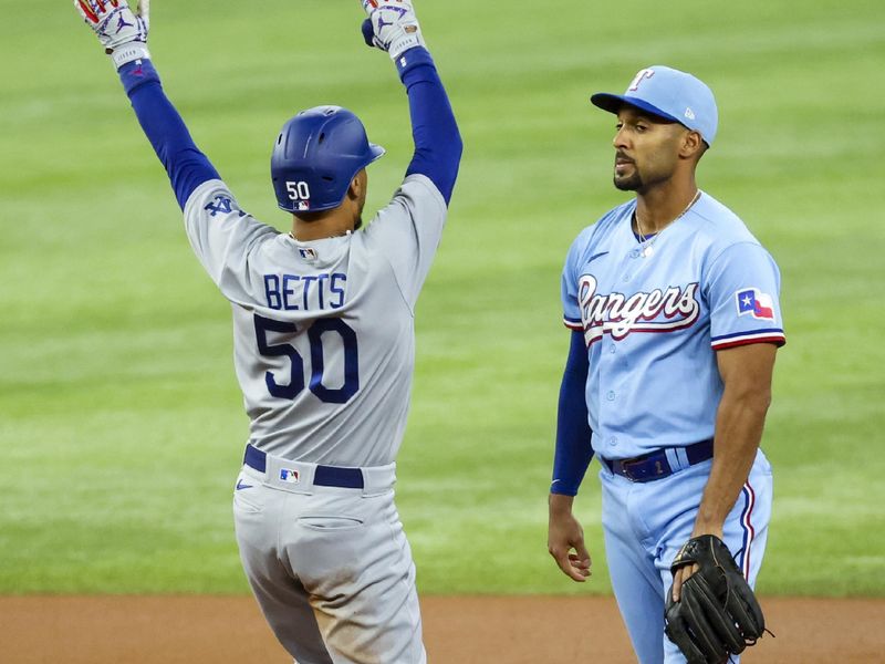 Jul 23, 2023; Arlington, Texas, USA;  Los Angeles Dodgers second baseman Mookie Betts (50) celebrates in front of Texas Rangers second baseman Marcus Semien (2) after hitting a double during the first inning at Globe Life Field. Mandatory Credit: Kevin Jairaj-USA TODAY Sports