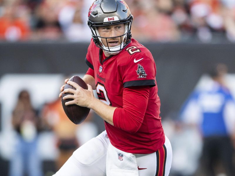 Tampa Bay Buccaneers quarterback Kyle Trask (2) carries the ball in the first half during an NFL preseason football game against the Cincinnati Bengals on Saturday, Aug. 10, 2024, in Cincinnati. (AP Photo/Emilee Chinn)