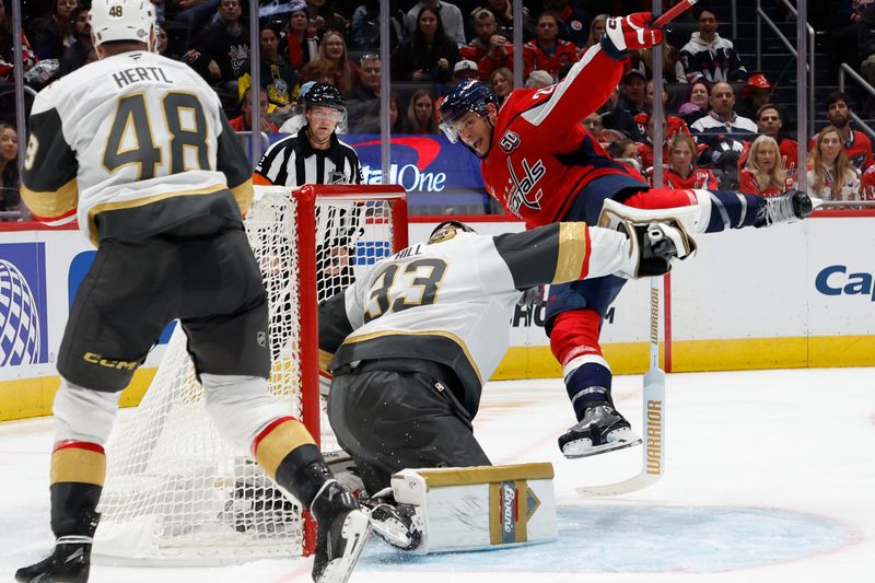 Oct 15, 2024; Washington, District of Columbia, USA; Washington Capitals center Nic Dowd (26) collides with Vegas Golden Knights goaltender Adin Hill (33) in the third period at Capital One Arena. Mandatory Credit: Geoff Burke-Imagn Images