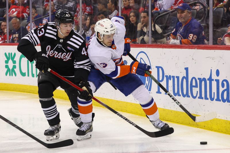 Apr 15, 2024; Newark, New Jersey, USA; New York Islanders center Mathew Barzal (13) plays the puck while being defended by New Jersey Devils defenseman Luke Hughes (43) during the third period at Prudential Center. Mandatory Credit: Ed Mulholland-USA TODAY Sports