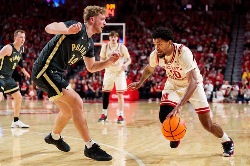 Feb 10, 2026; Lincoln, Nebraska, USA; Nebraska Cornhuskers guard Jamarques Lawrence (10) drives against Purdue Boilermakers guard Jack Benter (14) during the first half at Pinnacle Bank Arena. Mandatory Credit: Dylan Widger-Imagn Images