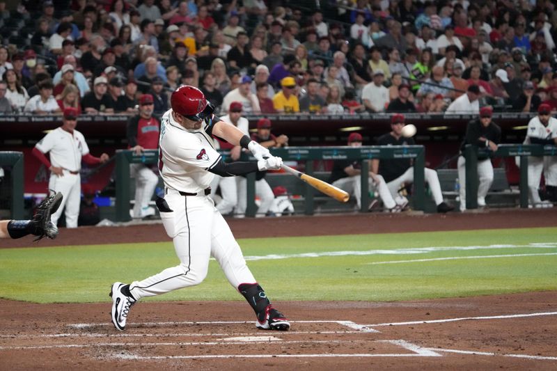 May 26, 2025; Phoenix, Arizona, USA; Arizona Diamondbacks second base Tim Tawa (13) hits a sacrifice fly RBI during the third inning at Chase Field. Mandatory Credit: Joe Camporeale-Imagn Images