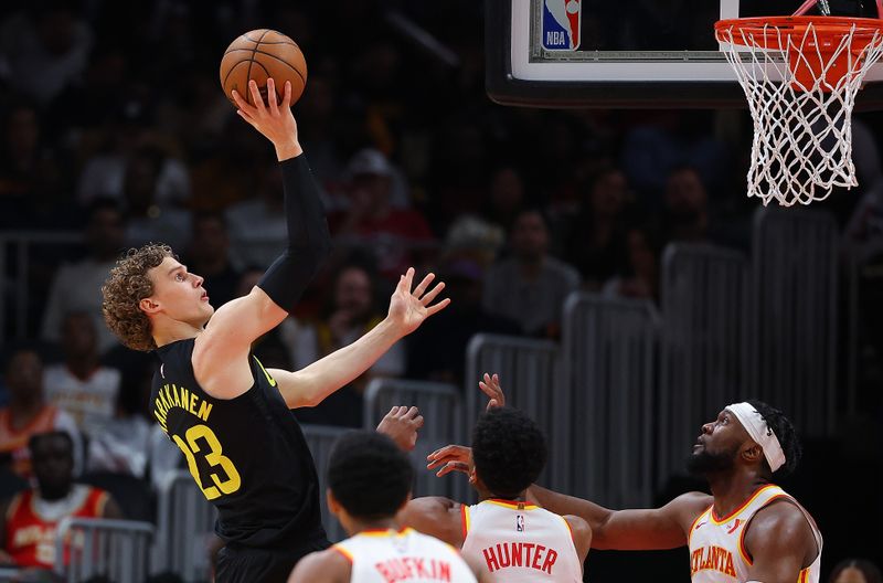 ATLANTA, GEORGIA - FEBRUARY 27:  Lauri Markkanen #23 of the Utah Jazz shoots against De'Andre Hunter #12 and Bruno Fernando #24 of the Atlanta Hawks during the first quarter at State Farm Arena on February 27, 2024 in Atlanta, Georgia.  NOTE TO USER: User expressly acknowledges and agrees that, by downloading and/or using this photograph, user is consenting to the terms and conditions of the Getty Images License Agreement.  (Photo by Kevin C. Cox/Getty Images)