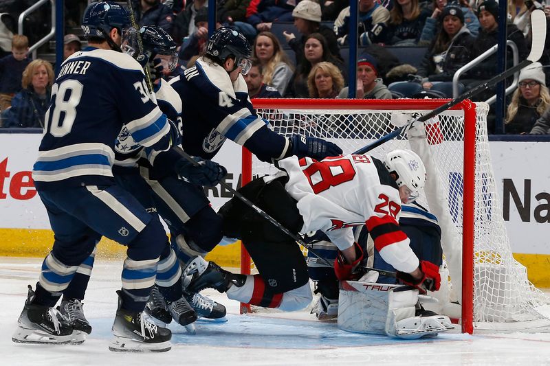 Jan 19, 2024; Columbus, Ohio, USA; New Jersey Devils right wing Timo Meier (28) falls onto Columbus Blue Jackets goalie Elvis Merzlikins (90) during the second period at Nationwide Arena. Mandatory Credit: Russell LaBounty-USA TODAY Sports