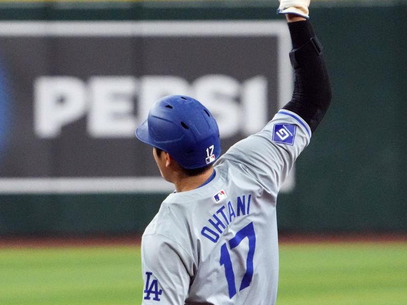 Sep 2, 2024; Phoenix, Arizona, USA; Los Angeles Dodgers two-way player Shohei Ohtani (17) steals second base against the Arizona Diamondbacks during the seventh inning at Chase Field. Mandatory Credit: Joe Camporeale-USA TODAY Sports