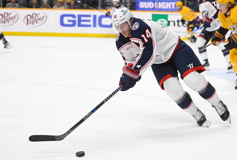 Jan 17, 2023; Nashville, Tennessee, USA;  Columbus Blue Jackets left wing Gustav Nyquist (14) clears the puck against the Nashville Predators during the first period at Bridgestone Arena. Mandatory Credit: Steve Roberts-USA TODAY Sports