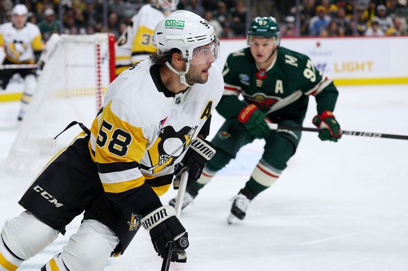 Oct 30, 2025; Saint Paul, Minnesota, USA; Pittsburgh Penguins defenseman Kris Letang (58) skates with the puck against the Minnesota Wild during the second period at Grand Casino Arena. Mandatory Credit: Matt Krohn-Imagn Images