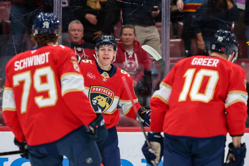 Feb 2, 2026; Sunrise, Florida, USA; Florida Panthers left wing Sandis Vilmanis (95) celebrates with center Cole Schwindt (79) and left wing A.J. Greer (10) after scoring against the Buffalo Sabres during the first period at Amerant Bank Arena. Mandatory Credit: Sam Navarro-Imagn Images
