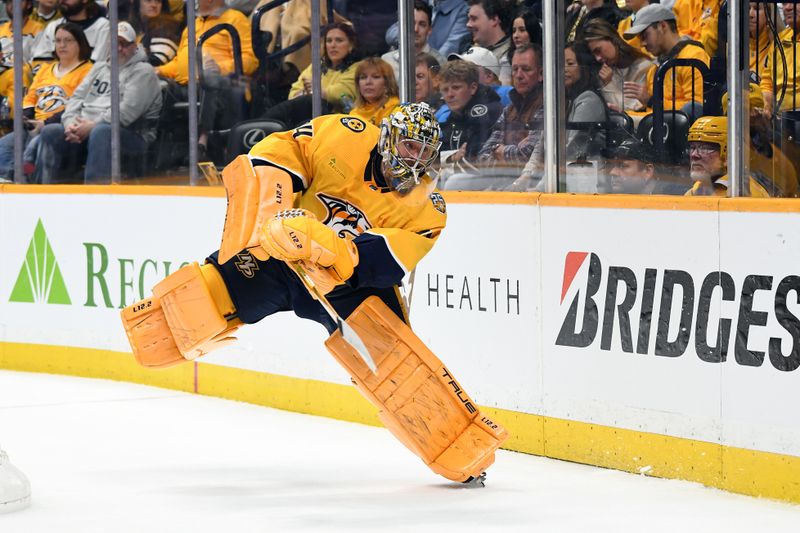 Nov 11, 2023; Nashville, Tennessee, USA; Nashville Predators goaltender Juuse Saros (74) plays the puck during the second period against the Arizona Coyotes at Bridgestone Arena. Mandatory Credit: Christopher Hanewinckel-USA TODAY Sports