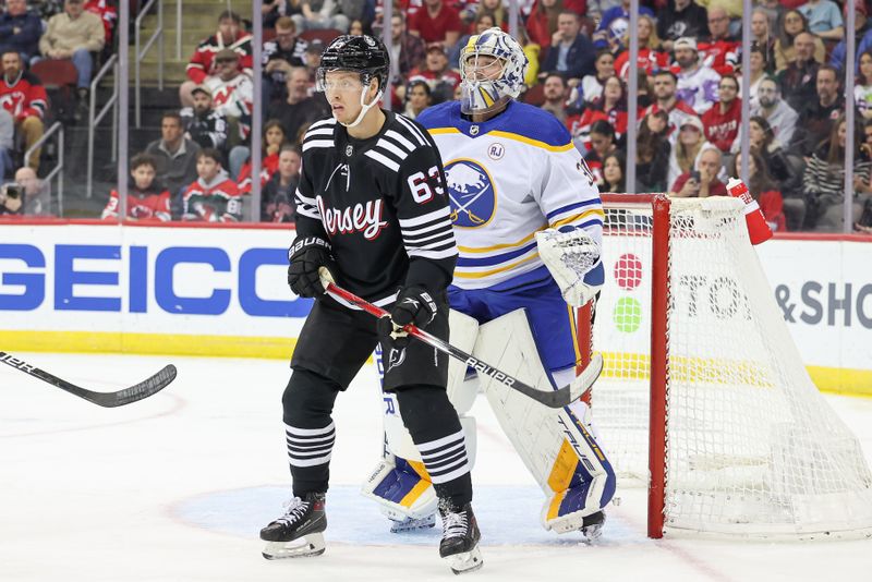 Oct 27, 2023; Newark, New Jersey, USA; New Jersey Devils left wing Jesper Bratt (63) sets in front of Buffalo Sabres goaltender Eric Comrie (31) during the first period at Prudential Center. Mandatory Credit: Vincent Carchietta-USA TODAY Sports