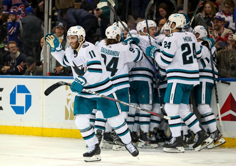 Oct 20, 2022; New York, New York, USA; San Jose Sharks center Luke Kunin (11) and teammates congratulate defenseman Erik Karlsson (65) after he scored the game-winning goal in overtime against the New York Rangers at Madison Square Garden. The Sharks won, 3-2. Mandatory Credit: Danny Wild-USA TODAY Sports