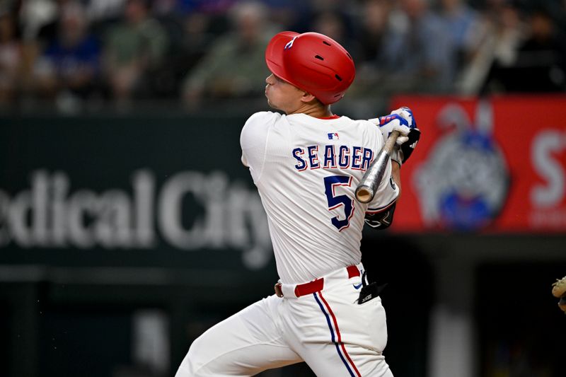 Jun 28, 2025; Arlington, Texas, USA; Texas Rangers shortstop Corey Seager (5) hits into a double play during the first inning against the Seattle Mariners at Globe Life Field. Mandatory Credit: Jerome Miron-Imagn Images