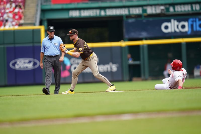 Jun 29, 2025; Cincinnati, Ohio, USA; San Diego Padres second baseman Jake Cronenworth (9) tags out Cincinnati Reds first baseman Spencer Steer (7) at second base in the second inning at Great American Ball Park. Mandatory Credit: Frank Bowen IV/ The USAToday Network via Imagn Images