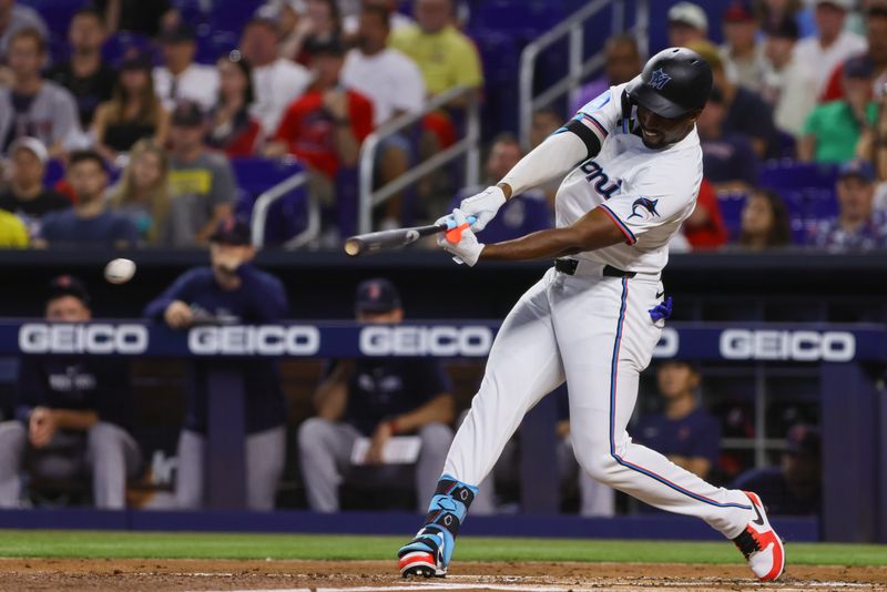 Jul 3, 2024; Miami, Florida, USA; Miami Marlins right fielder Jesus Sanchez (12) hits an RBI single against the Boston Red Sox during the first inning at loanDepot Park. Mandatory Credit: Sam Navarro-USA TODAY Sports