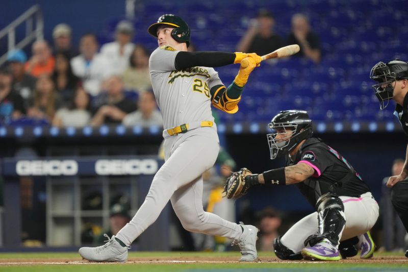 May 3, 2025; Miami, Florida, USA;  Oakland Athletics designated hitter Brent Rooker (25) hits a solo home run in the first inning against the Miami Marlins at loanDepot Park. Mandatory Credit: Jim Rassol-Imagn Images