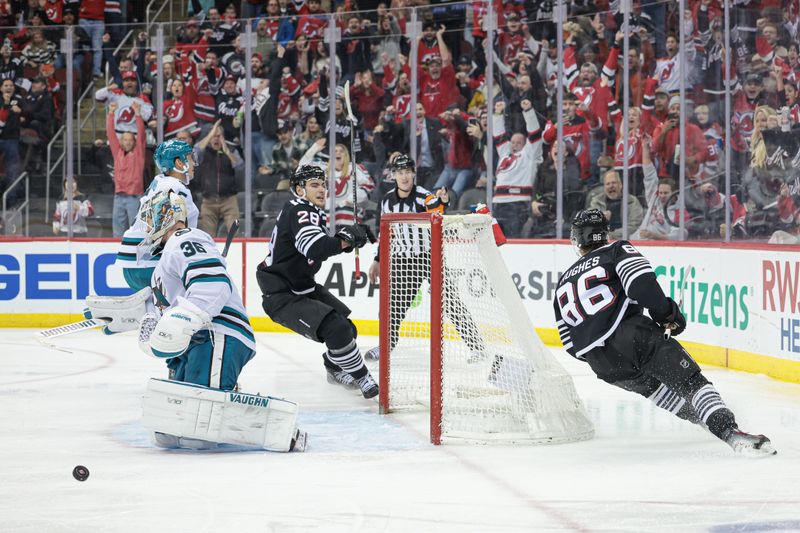 Dec 1, 2023; Newark, New Jersey, USA; New Jersey Devils center Jack Hughes (86) celebrates with right wing Timo Meier (28) after scoring a goal past San Jose Sharks goaltender Kaapo Kahkonen (36) during the third period at Prudential Center. Mandatory Credit: Vincent Carchietta-USA TODAY Sports