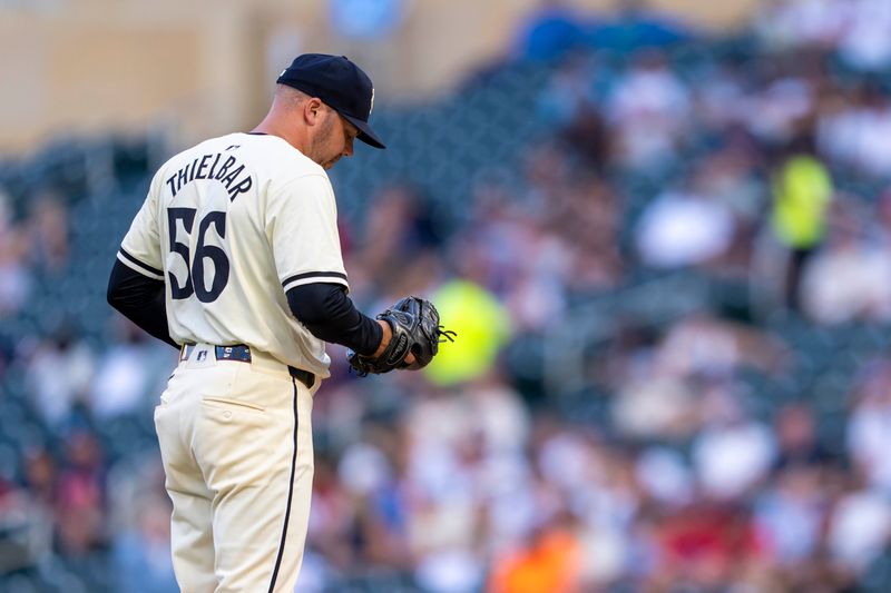 Jun 11, 2024; Minneapolis, Minnesota, USA; Minnesota Twins pitcher Caleb Thielbar (56) looks on before delivering a pitch against the Colorado Rockies in the sixth inning at Target Field. Mandatory Credit: Jesse Johnson-USA TODAY Sports