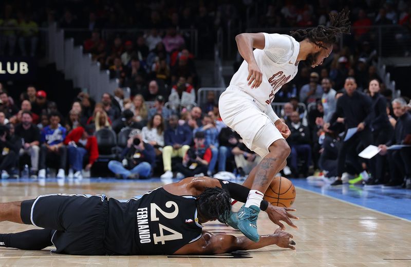 ATLANTA, GEORGIA - MARCH 06:  Bruno Fernando #24 of the Atlanta Hawks dives for a loose ball against Darius Garland #10 of the Cleveland Cavaliers during the second quarter at State Farm Arena on March 06, 2024 in Atlanta, Georgia.  NOTE TO USER: User expressly acknowledges and agrees that, by downloading and/or using this photograph, user is consenting to the terms and conditions of the Getty Images License Agreement.  (Photo by Kevin C. Cox/Getty Images)