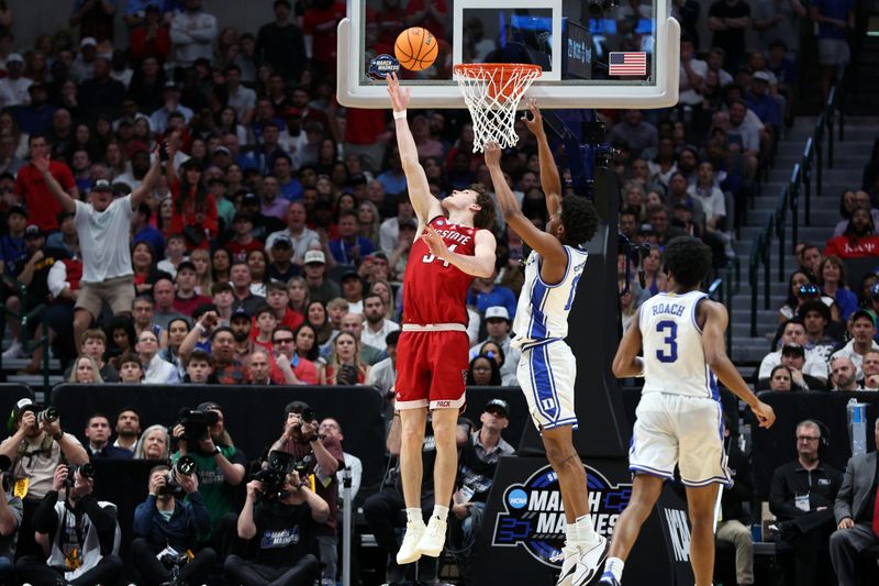 Mar 31, 2024; Dallas, TX, USA; North Carolina State Wolfpack forward Ben Middlebrooks (34) shoots against Duke Blue Devils forward Sean Stewart (13) in the second half in the finals of the South Regional of the 2024 NCAA Tournament at American Airline Center. Mandatory Credit: Tim Heitman-USA TODAY Sports