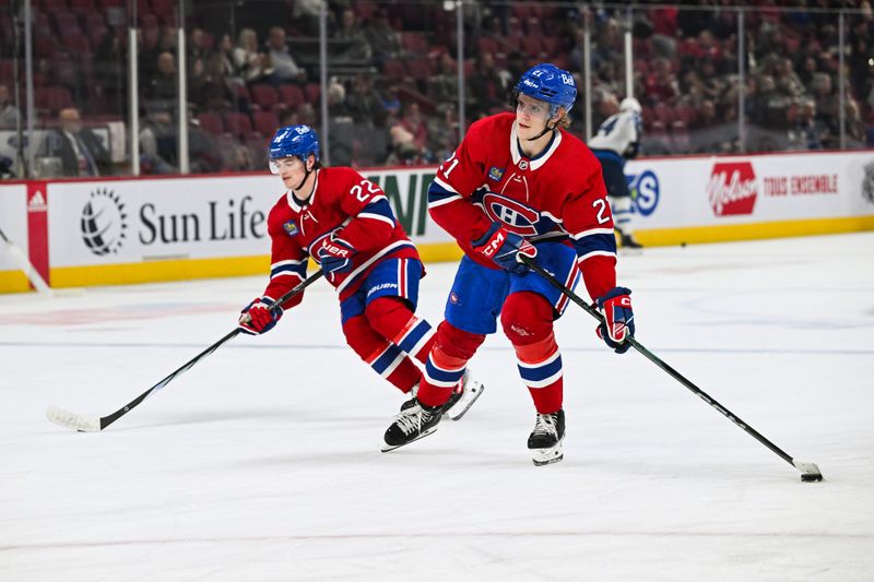 Oct 28, 2023; Montreal, Quebec, CAN; Montreal Canadiens defenseman Kaiden Guhle (21) skates beside right wing Cole Caufield (22) with a puck during warm-up before the game against the Winnipeg Jets at Bell Centre. Mandatory Credit: David Kirouac-USA TODAY Sports