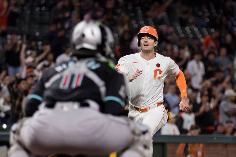 Sep 3, 2024; San Francisco, California, USA;  Arizona Diamondbacks catcher Jose Herrera (11) watches as San Francisco Giants right fielder Mike Yastrzemski (5) runs home to score during the ninth inning at Oracle Park. Mandatory Credit: John Hefti-Imagn Images