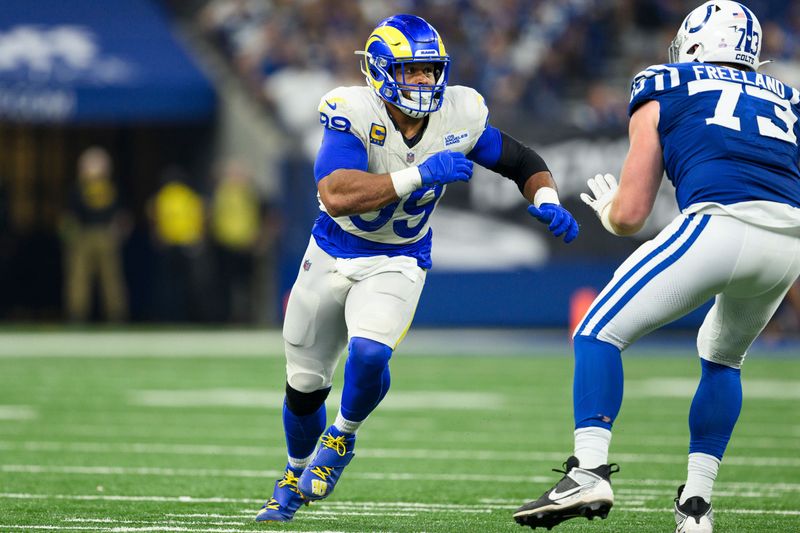 Los Angeles Rams defensive tackle Aaron Donald (99) rushes around the edge during an NFL football game against the Indianapolis Colts, Sunday, Oct. 1, 2023, in Indianapolis. (AP Photo/Zach Bolinger)