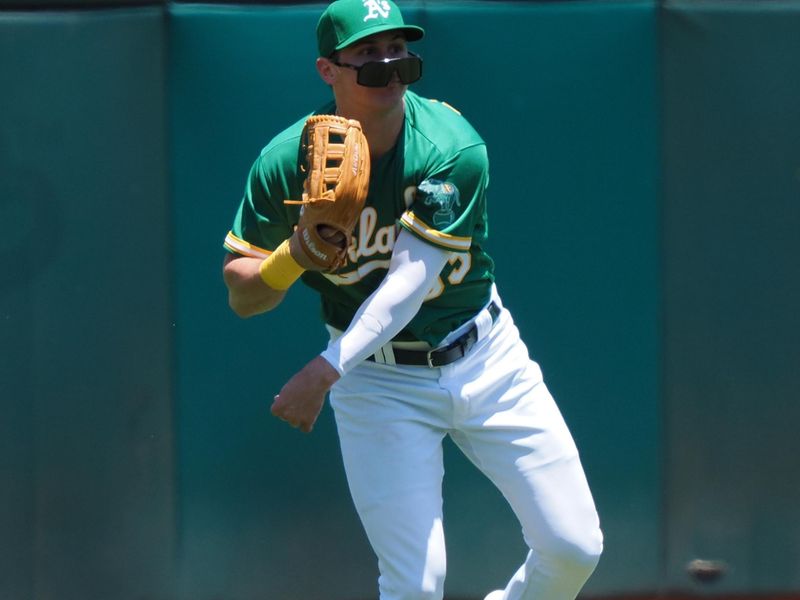 Jun 29, 2023; Oakland, California, USA; Oakland Athletics left fielder JJ Bleday (33) glasses slip down his face as he throws the ball infield against the New York Yankees during the fourth inning at Oakland-Alameda County Coliseum. Mandatory Credit: Kelley L Cox-USA TODAY Sports