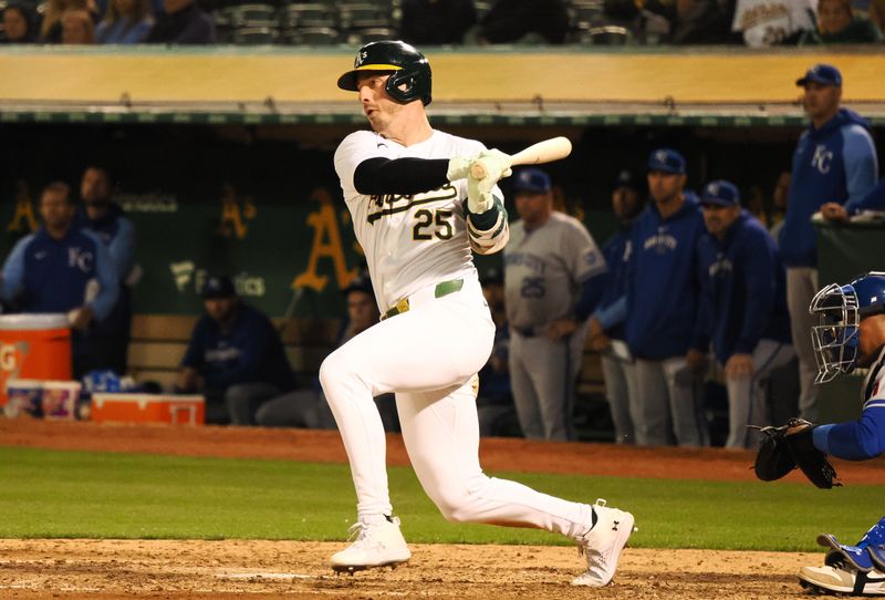 Jun 19, 2024; Oakland, California, USA; Oakland Athletics designated hitter Brent Rooker (25) hits an RBI single against the Kansas City Royals during the seventh inning at Oakland-Alameda County Coliseum. Mandatory Credit: Kelley L Cox-USA TODAY Sports