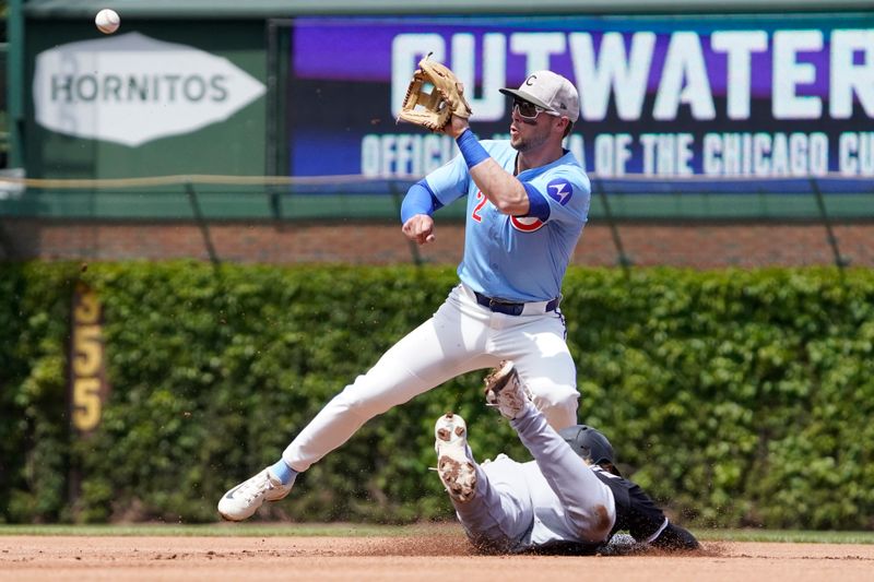 May 16, 2025; Chicago, Illinois, USA; Chicago White Sox shortstop Chase Meidroth (10) steals second base as Chicago Cubs second base Nico Hoerner (2) takes the throw during the first inning at Wrigley Field. Mandatory Credit: David Banks-Imagn Images