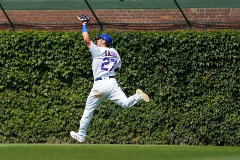 Jul 23, 2023; Chicago, Illinois, USA; Chicago Cubs right fielder Seiya Suzuki (27) makes a catch on St. Louis Cardinals designated hitter Brendan Donovan (33)  during the seventh inning at Wrigley Field. Mandatory Credit: David Banks-USA TODAY Sports