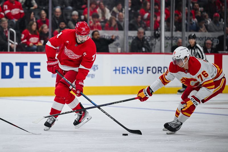 Nov 27, 2024; Detroit, Michigan, USA; Detroit Red Wings center Dylan Larkin (71) shoots as Calgary Flames center Martin Pospisil (76) defends during the second period at Little Caesars Arena. Mandatory Credit: Tim Fuller-Imagn Images