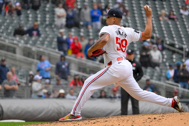 May 27, 2024; Minneapolis, Minnesota, USA; Minnesota Twins relief pitcher Jhoan Duran (59) delivers a pitch against the Kansas City Royals during the ninth inning at Target Field. Mandatory Credit: Nick Wosika-USA TODAY Sports