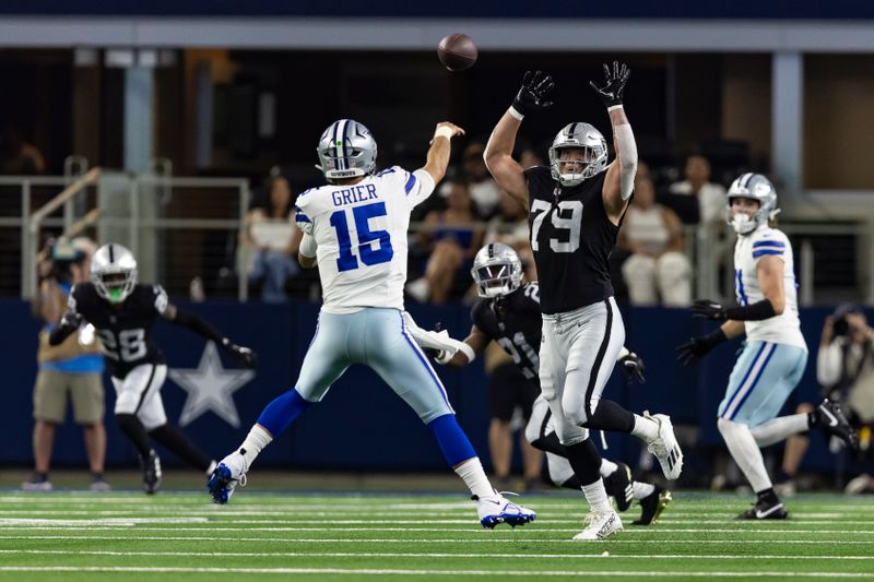 Las Vegas Raiders defensive end George Tarlas (79) attempts to block a pas by Dallas Cowboys quarterback Will Grier (15) during the first half of an NFL football game, Saturday, Aug. 26, 2023, in Arlington, Texas. Dallas won 31-16. (AP Photo/Brandon Wade)