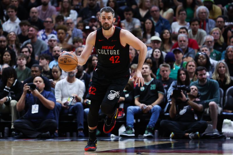 MIAMI, FLORIDA - FEBRUARY 11: Kevin Love #42 of the Miami Heat dribbles the ball against the Boston Celtics during the third quarter of the game at Kaseya Center on February 11, 2024 in Miami, Florida. NOTE TO USER: User expressly acknowledges and agrees that, by downloading and or using this photograph, User is consenting to the terms and conditions of the Getty Images License Agreement. (Photo by Megan Briggs/Getty Images)