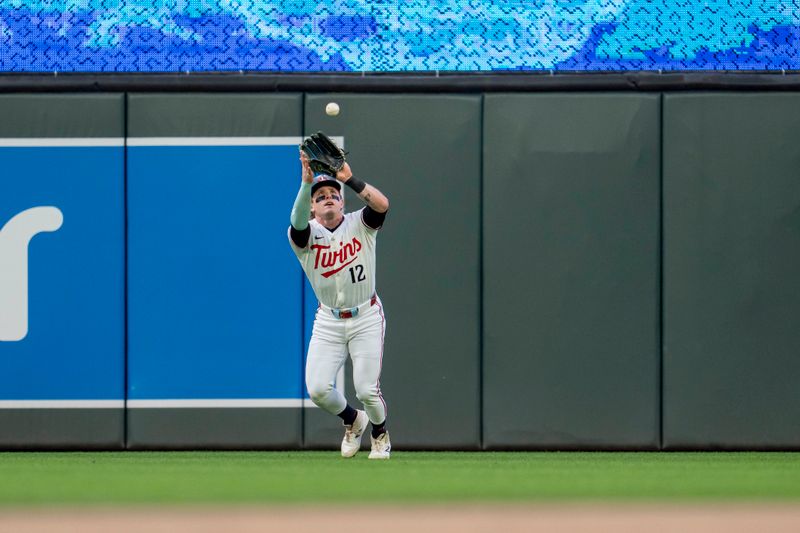 May 19, 2025; Minneapolis, Minnesota, USA; Minnesota Twins center fielder Harrison Bader (12) catches a fly ball against the Cleveland Guardians in the first inning at Target Field. Mandatory Credit: Jesse Johnson-Imagn Images
