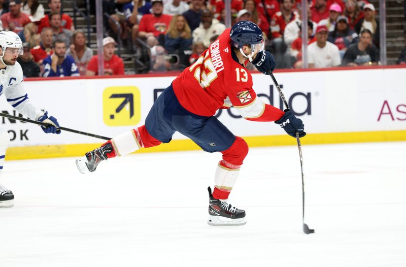 May 11, 2025; Sunrise, Florida, USA; Florida Panthers center Sam Reinhart (13) passes the puck against the Toronto Maple Leafs during the second period in game four of the second round of the 2025 Stanley Cup Playoffs at Amerant Bank Arena. Mandatory Credit: Kim Klement Neitzel-Imagn Images
