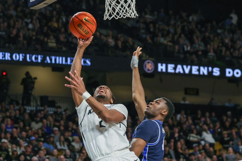 Jan 13, 2024; Orlando, Florida, USA; UCF Knights guard Shemarri Allen (2) goes to the basket against Brigham Young Cougars forward Atiki Ally Atiki (4) during the second half at Addition Financial Arena. Mandatory Credit: Mike Watters-USA TODAY Sports