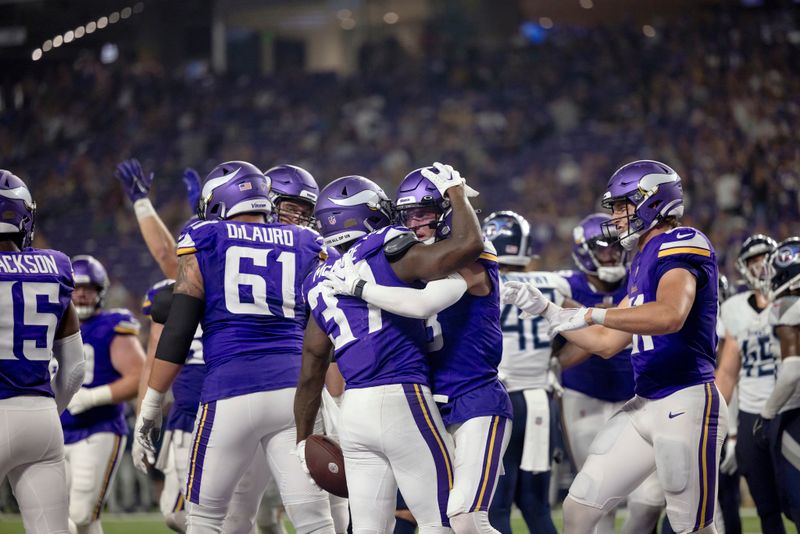 Minnesota Vikings running back DeWayne McBride (37) celebrates with teammates after scoring a touchdown during an NFL preseason football game against the Tennessee Titans, Saturday, Aug. 19, 2023 in Minneapolis. Tennessee won 24-16. (AP Photo/Stacy Bengs)