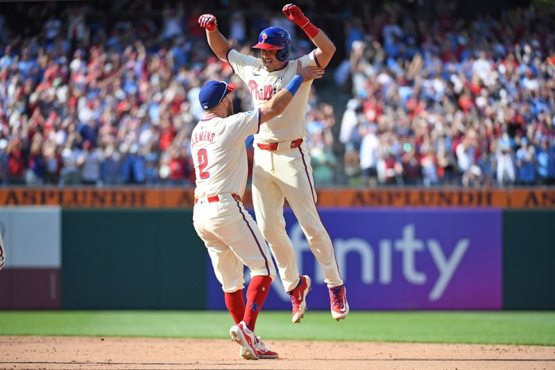 Sep 15, 2024; Philadelphia, Pennsylvania, Philadelphia Phillies catcher J.T. Realmuto (10) celebrates his walk-off RBI single with first base Kody Clemens (2) during the ninth inning against the New York Mets USA; at Citizens Bank Park. Mandatory Credit: Eric Hartline-Imagn Images