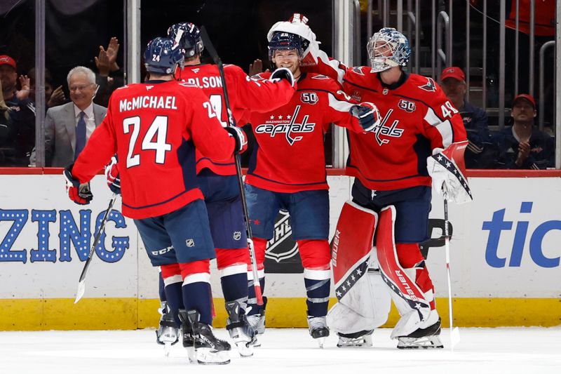 Oct 29, 2024; Washington, District of Columbia, USA; Washington Capitals center Nic Dowd (26) celebrates with teammates after scoring a goal after scoring an empty net goal against the New York Rangers in the third period at Capital One Arena. Mandatory Credit: Geoff Burke-Imagn Images