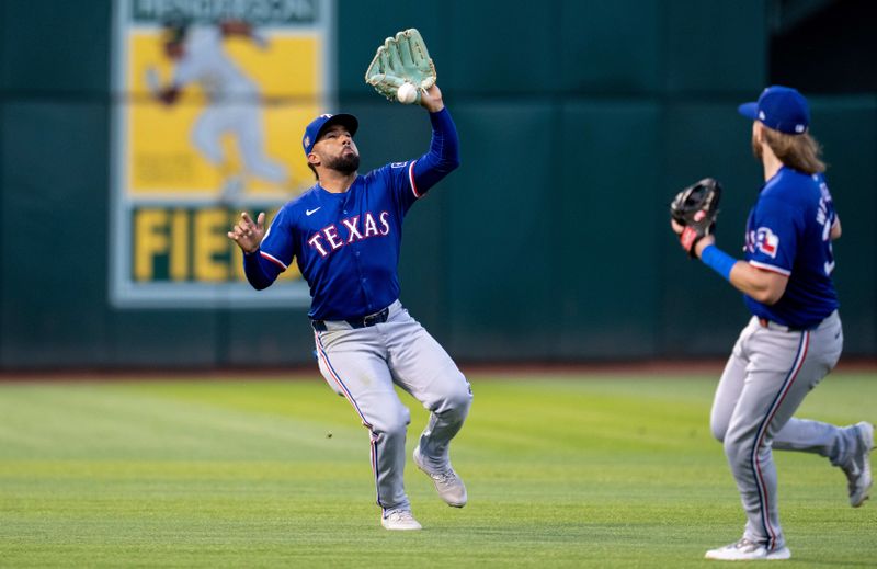 May 6, 2024; Oakland, California, USA; Texas Rangers first baseman Ezequiel Duran (20) makes an error during the fifth inning against the Oakland Athletics at Oakland-Alameda County Coliseum. Mandatory Credit: Neville E. Guard-USA TODAY Sports