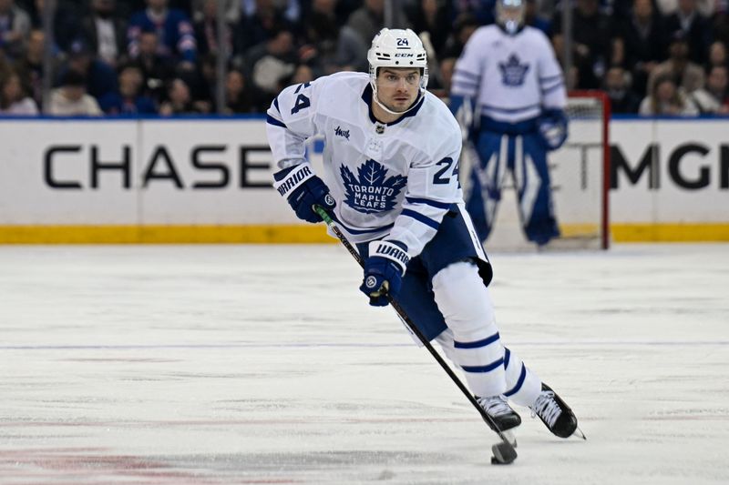 Mar 20, 2025; New York, New York, USA;  Toronto Maple Leafs left wing Scott Laughton (24) skates with the puck against the New York Rangers during the first period at Madison Square Garden. Mandatory Credit: Dennis Schneidler-Imagn Images