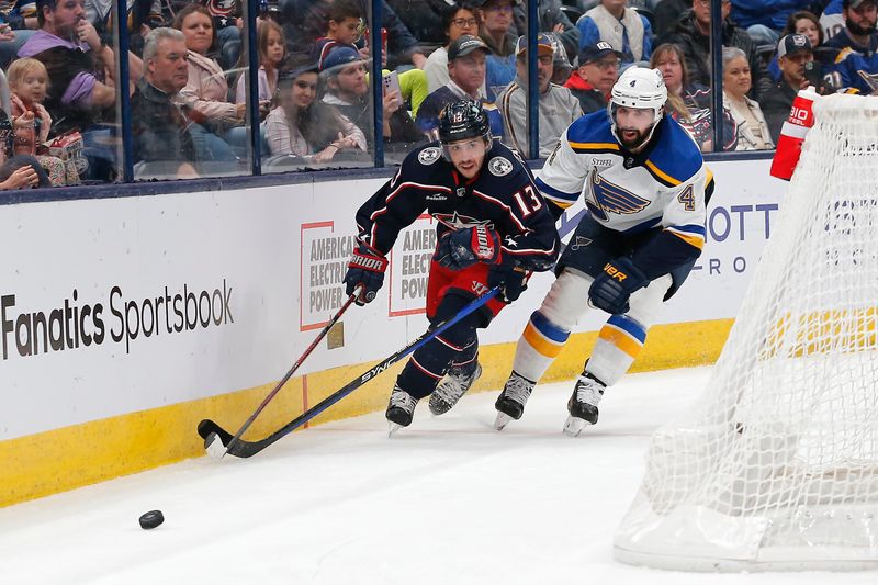 Dec 8, 2023; Columbus, Ohio, USA; Columbus Blue Jackets left wing Johnny Gaudreau (13) and St. Louis Blues defenseman Nick Leddy (4) chase after a loose puck during the second period at Nationwide Arena. Mandatory Credit: Russell LaBounty-USA TODAY Sports