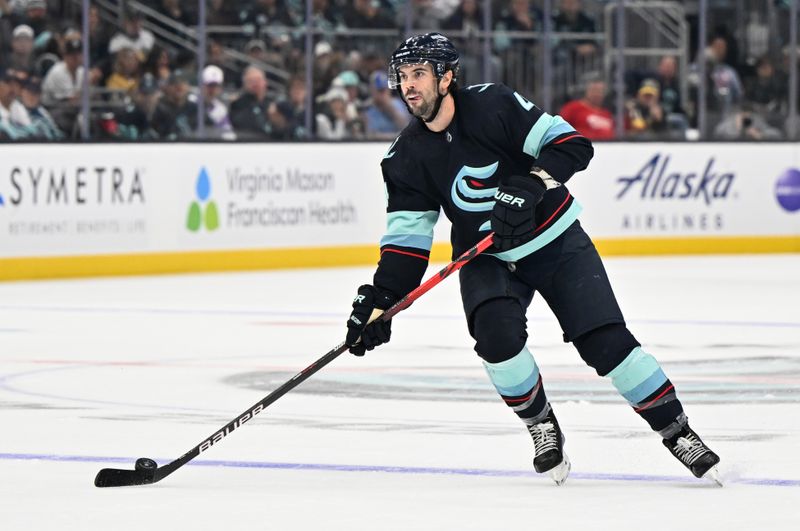 Oct 15, 2022; Seattle, Washington, USA; Seattle Kraken defenseman Justin Schultz (4) advances the puck against the Vegas Golden Knights during the third period at Climate Pledge Arena. Vegas defeated defeated Seattle 5-2. Mandatory Credit: Steven Bisig-USA TODAY Sports